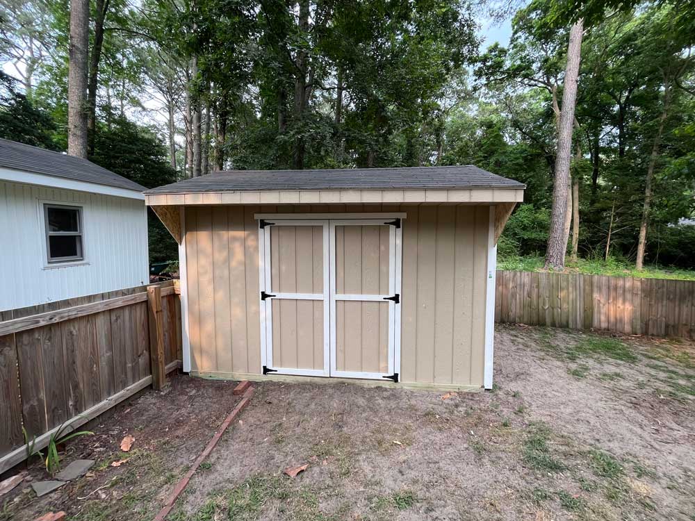 Exterior shed renovation with new doors and hardware.