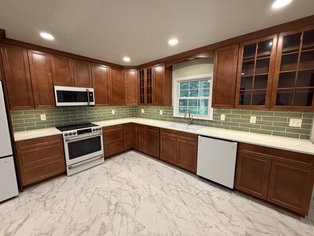 Kitchen with brown wood cabinets and a tiled backsplash with a quarts countertop